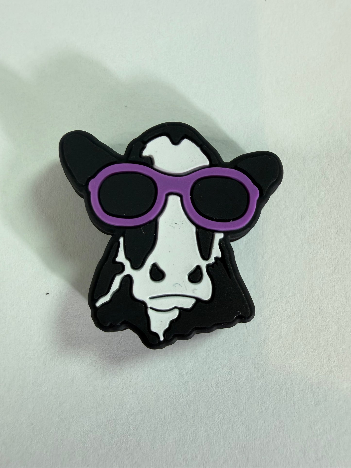 Focal 2d black and white cow with purple glasses