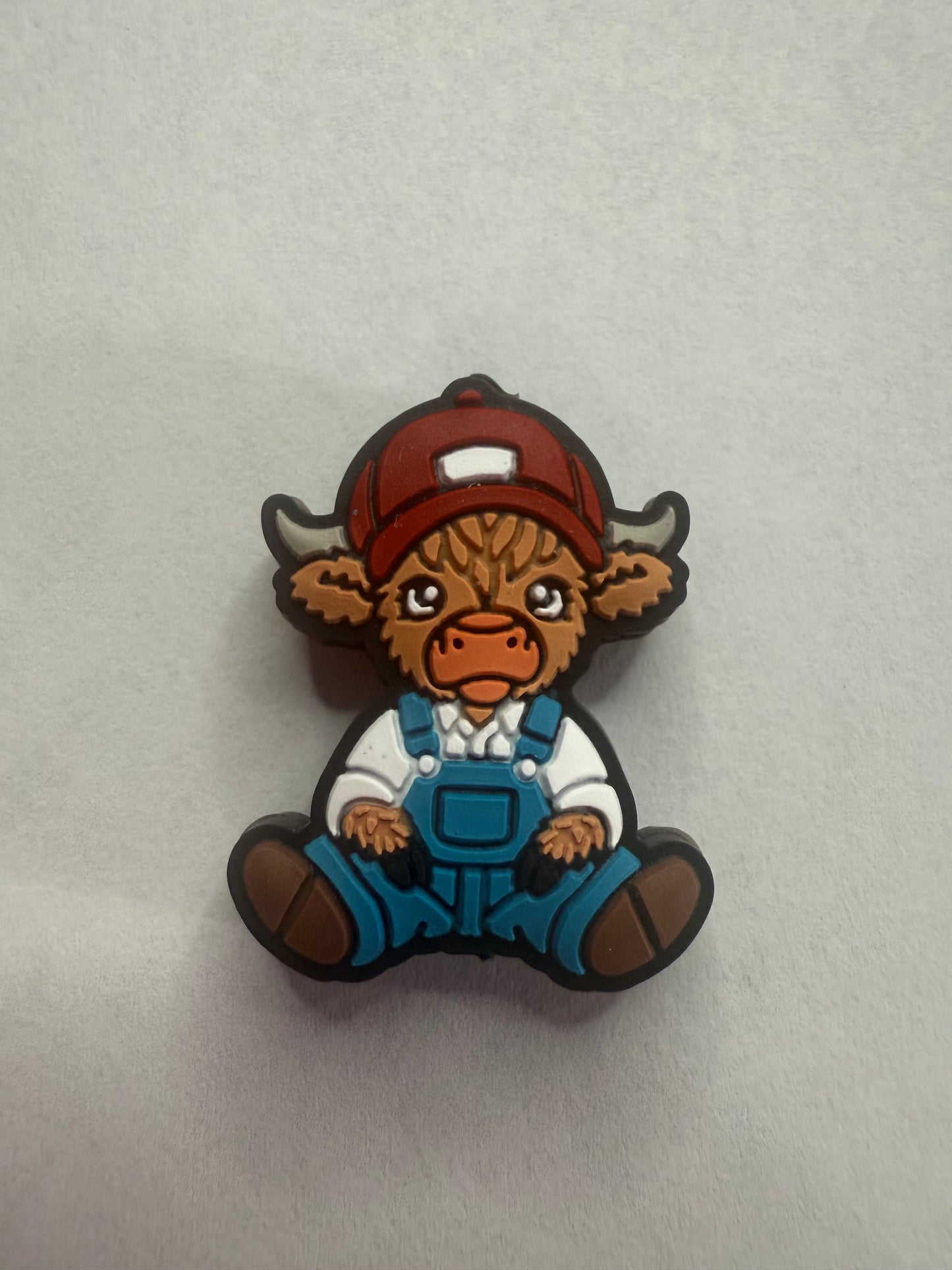 Focal 2d highland cow with hat and overalls