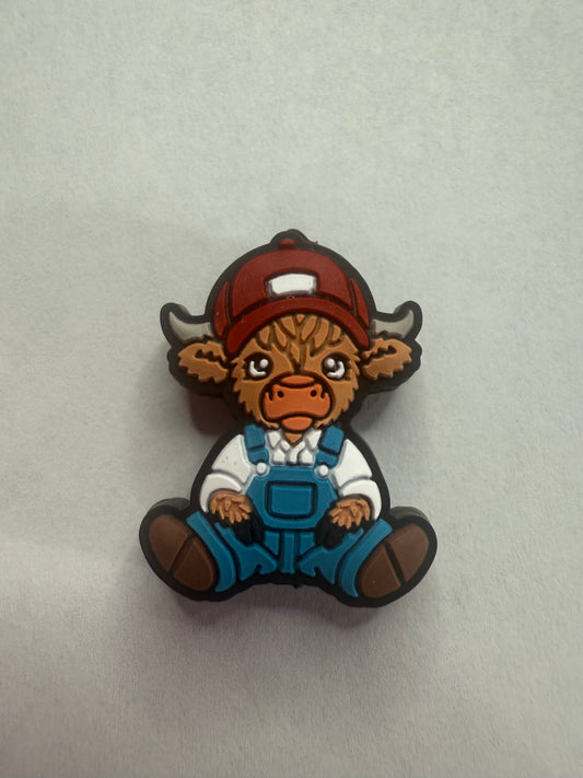 Focal 2d highland cow with hat and overalls