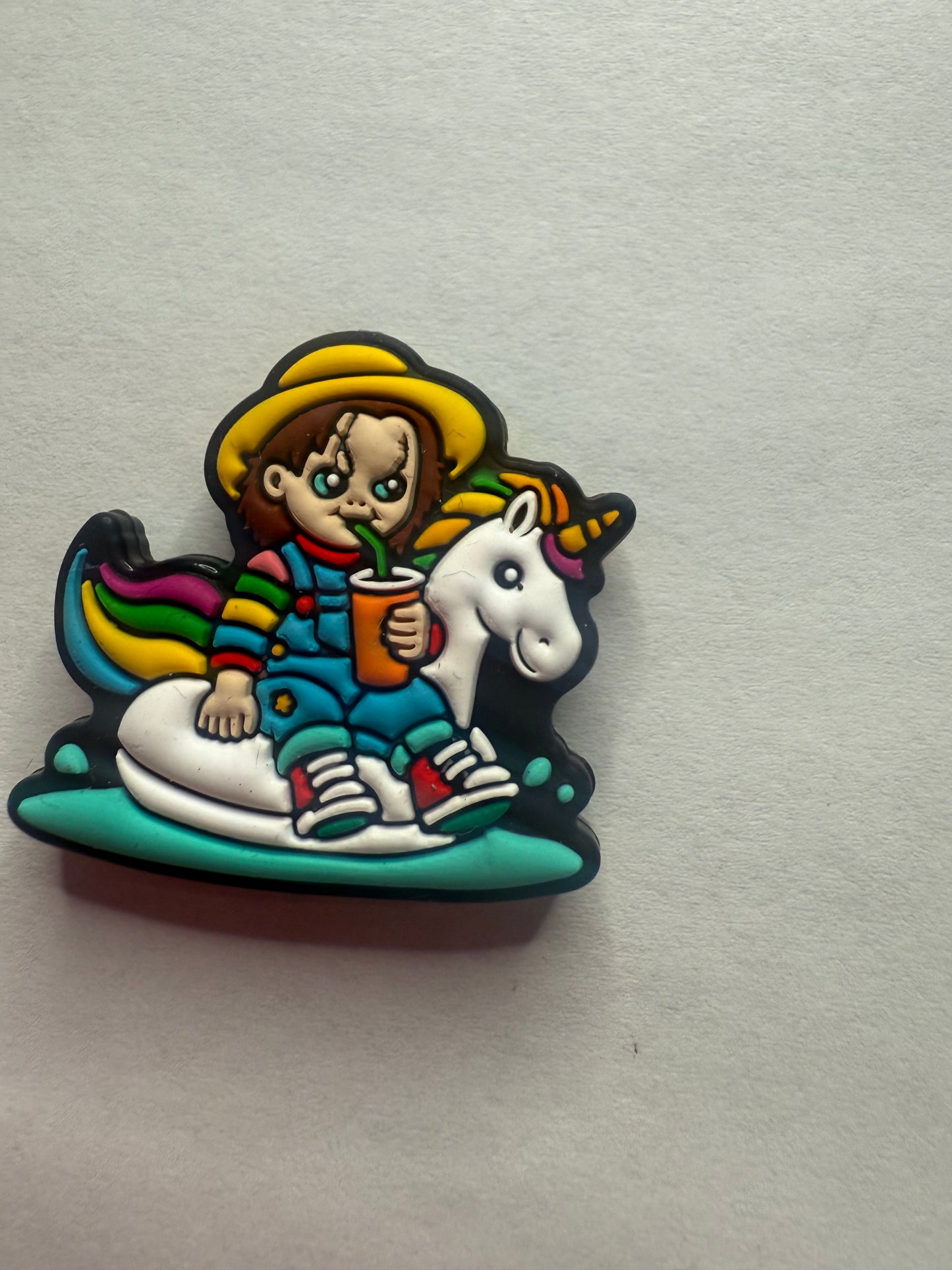 Focal 2d  Chucky sitting on a unicorn pool float